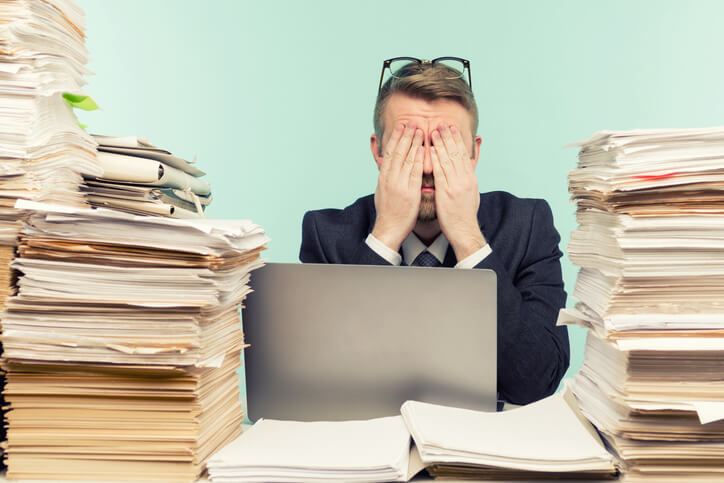Close-up image of a stressful businessman tired from his work on the foreground